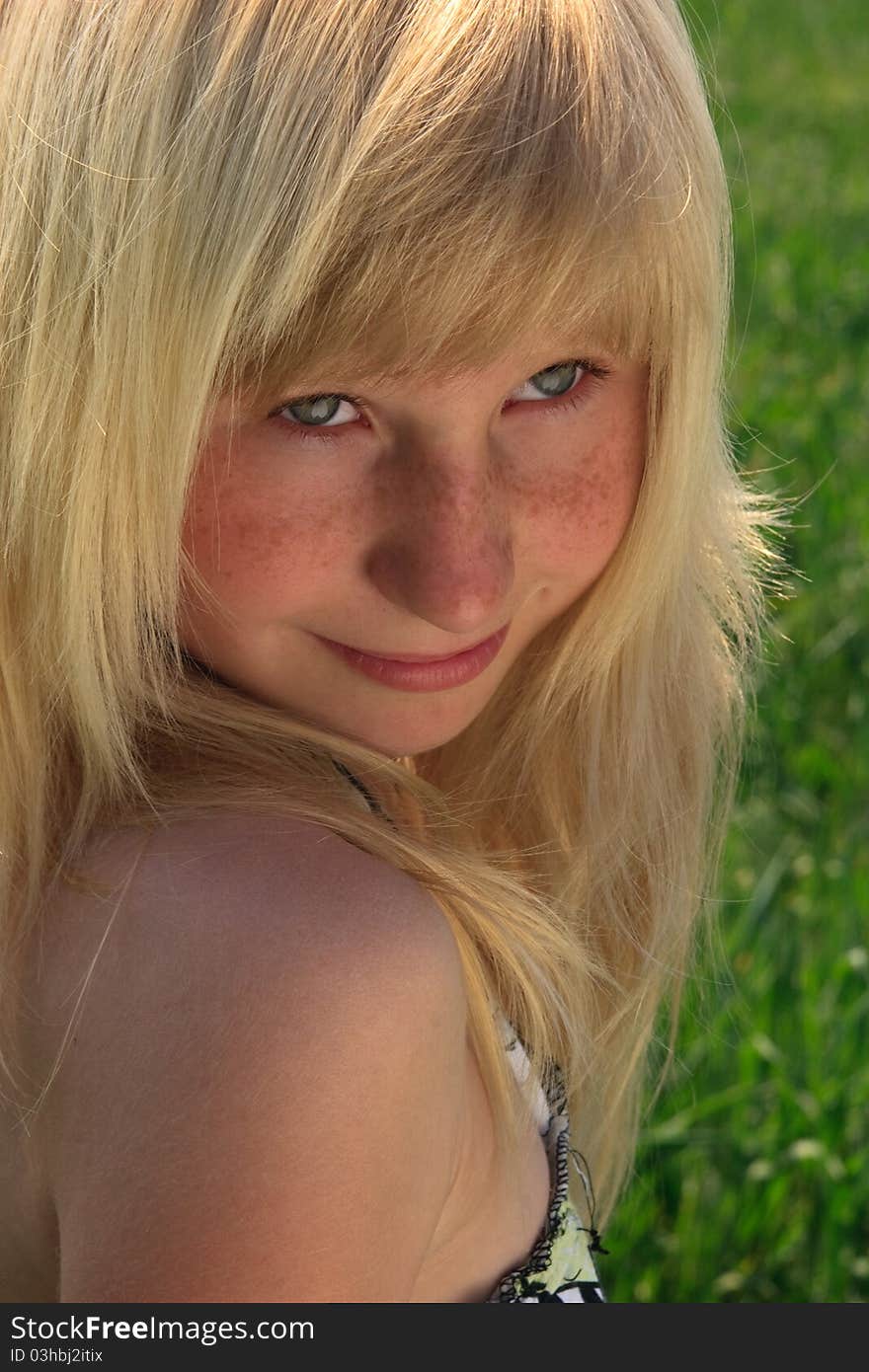 Close-up portrait of the young girl with a smile looking upwards