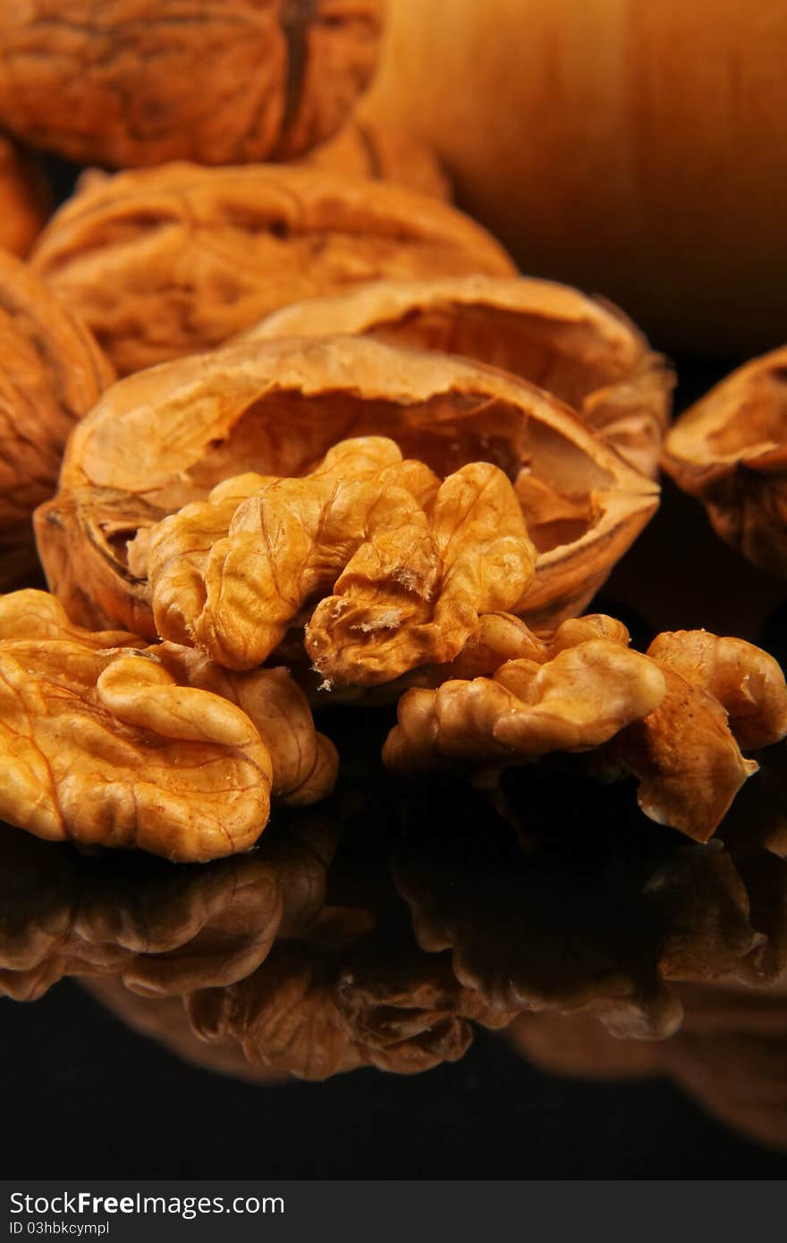 Walnuts. Close up on black reflecting background