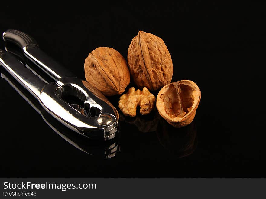 Walnuts. Close up on black reflecting background