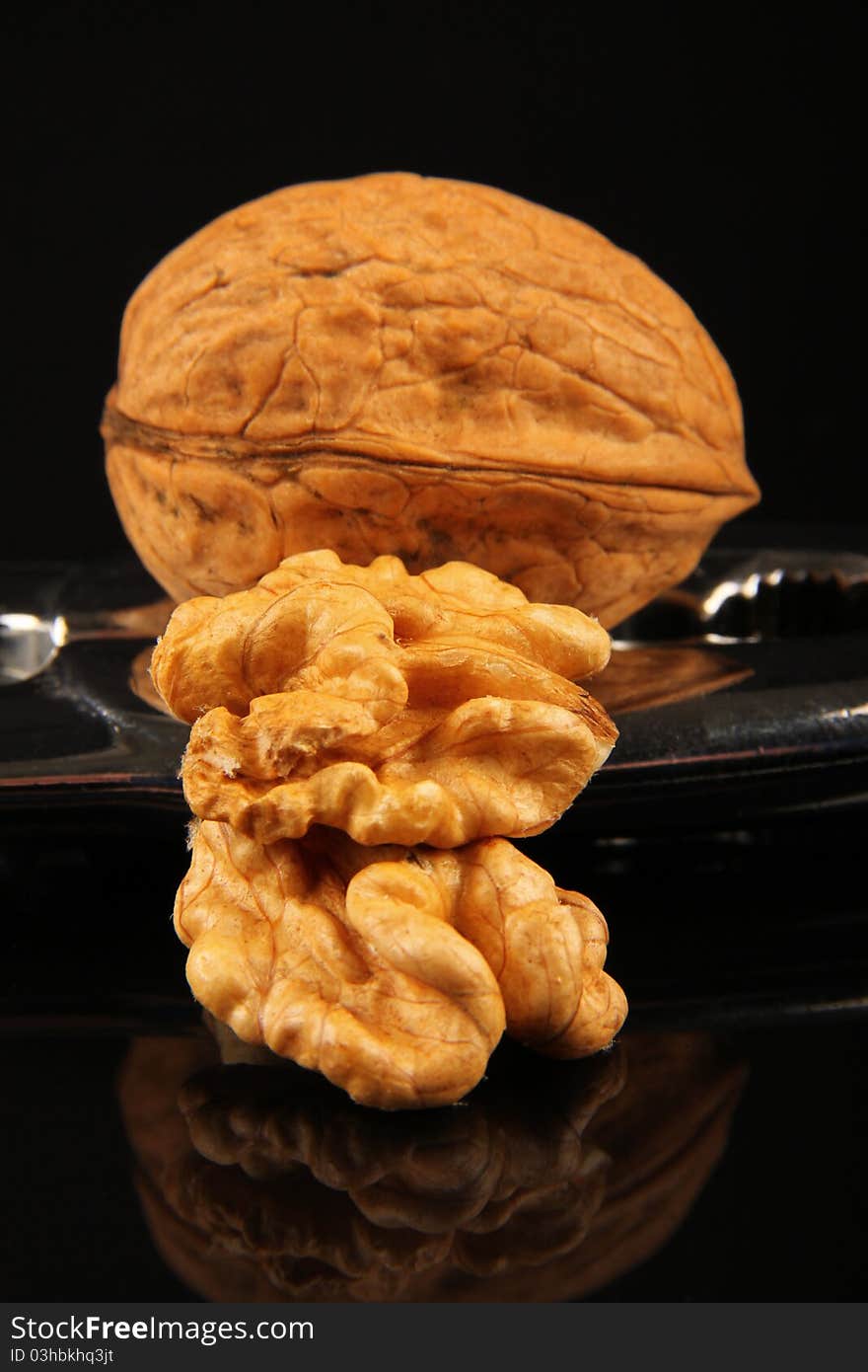 Walnuts. Close up on black reflecting background