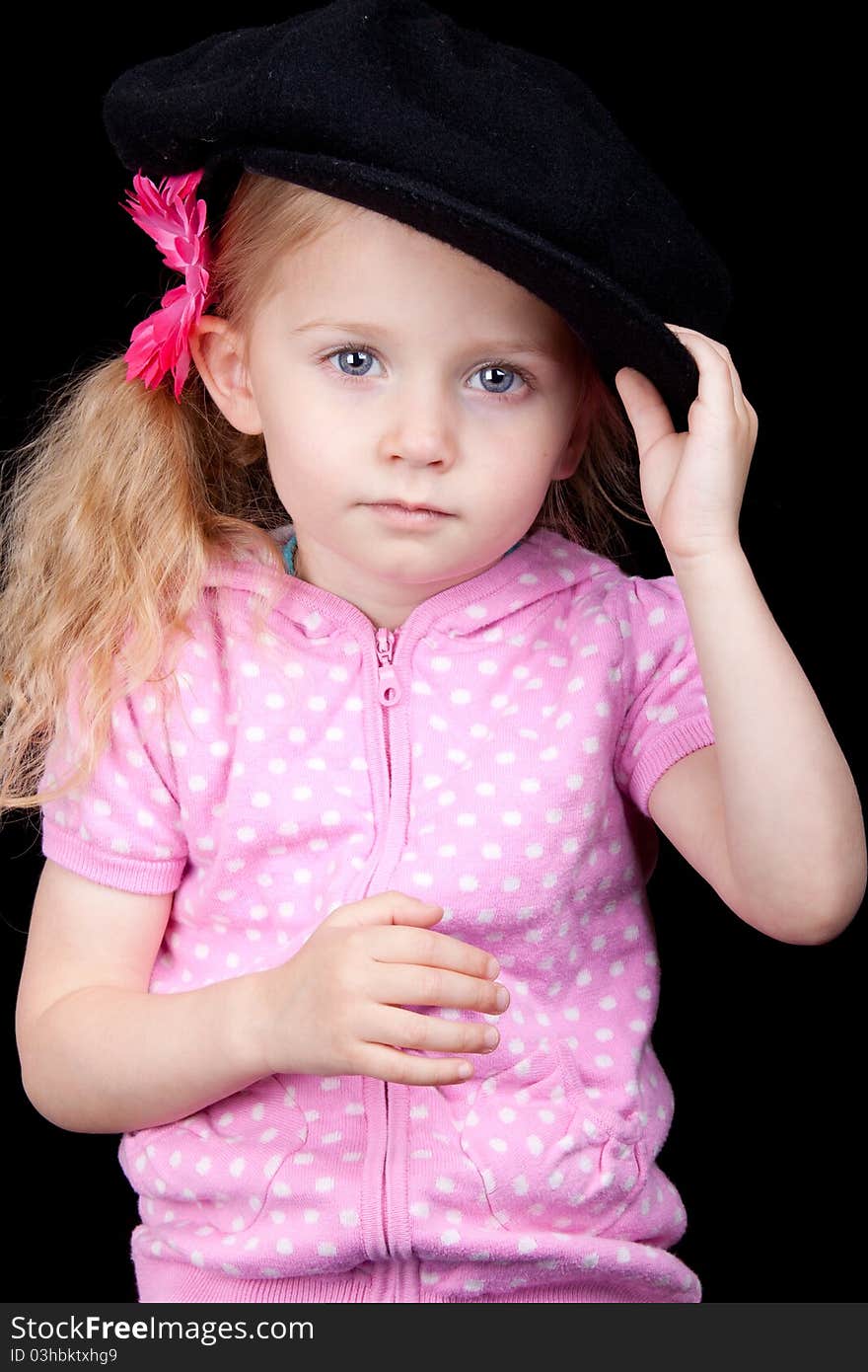 A photograph of a cute girl with a black background. A photograph of a cute girl with a black background.