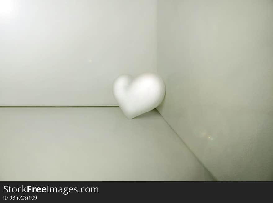 White plastic heart placed in a corner. White plastic heart placed in a corner