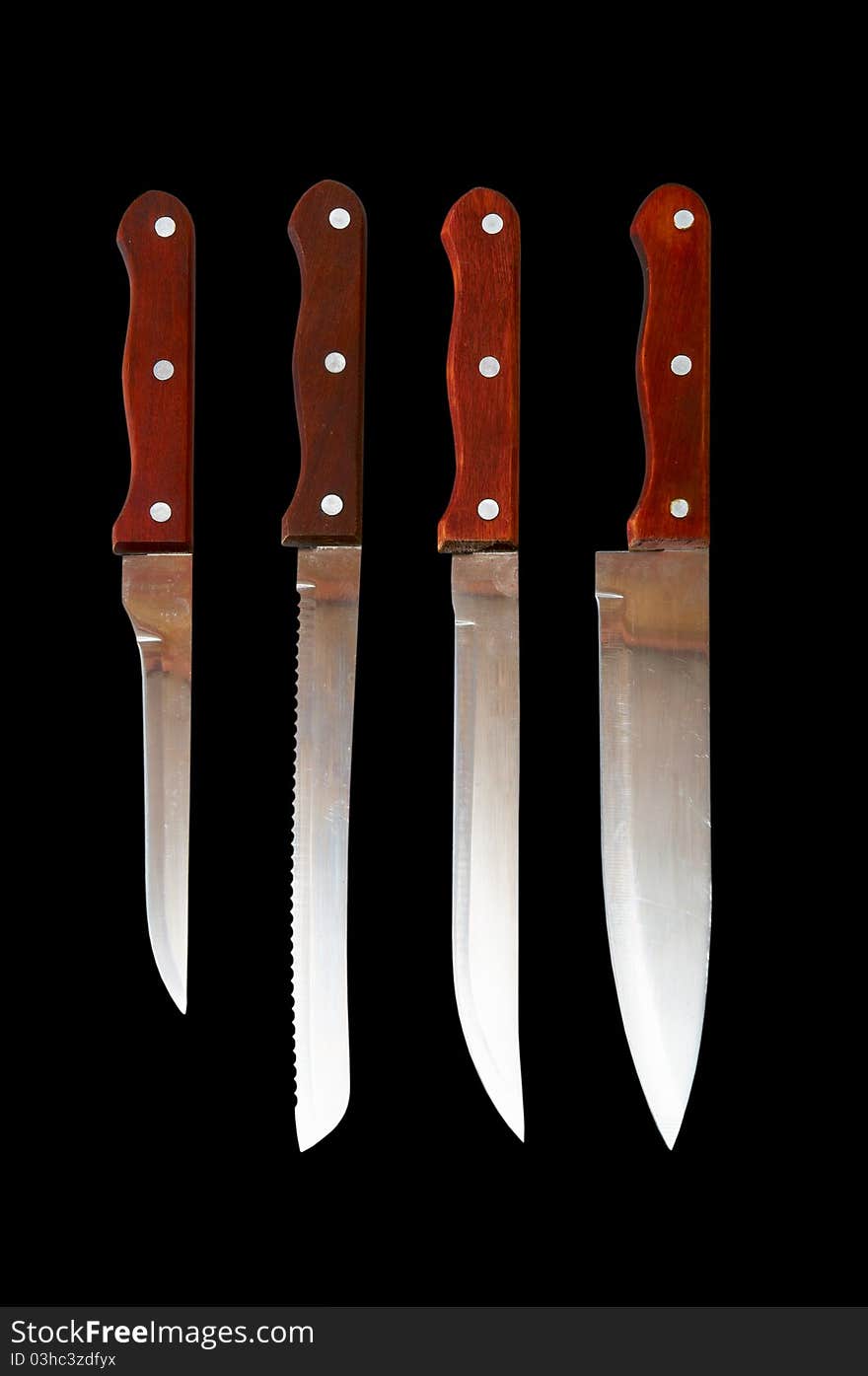 Three kitchen knives isolated on a black background