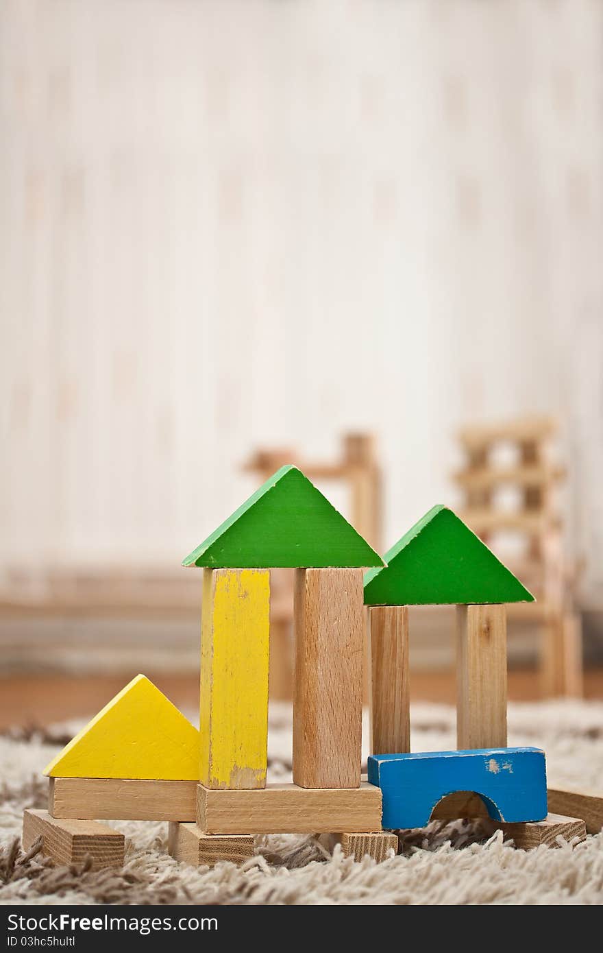 Wooden toy blocks construction on carpet