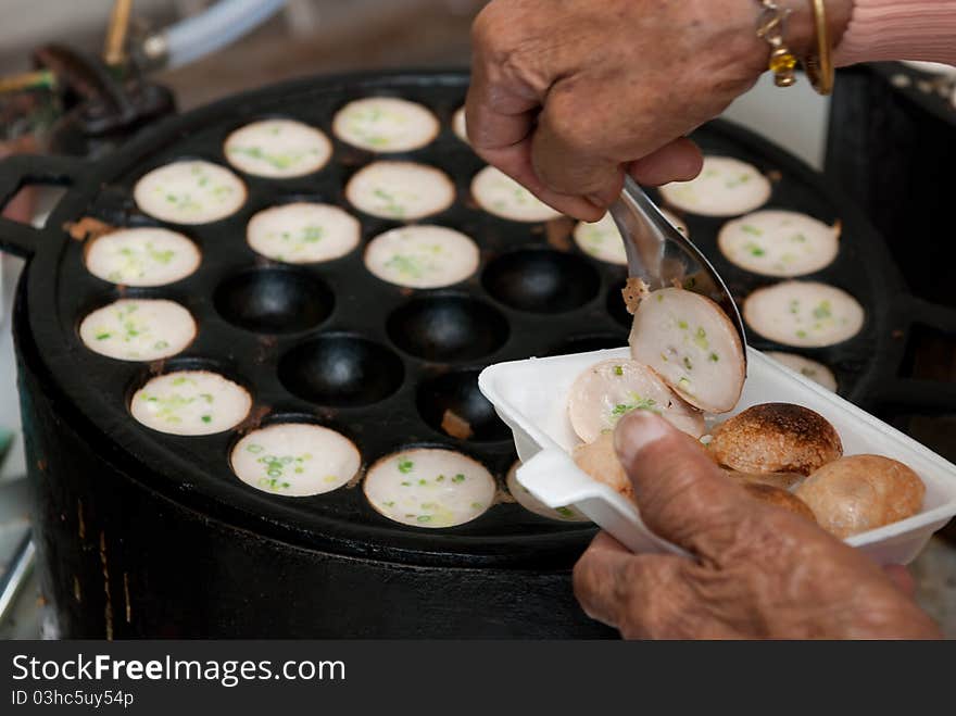 Kind of Thai sweetmeat . Coconut milk mix with powder fried dessert.