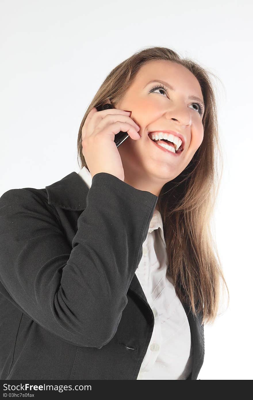 The business woman speaks on the phone and is happy. The business woman speaks on the phone and is happy