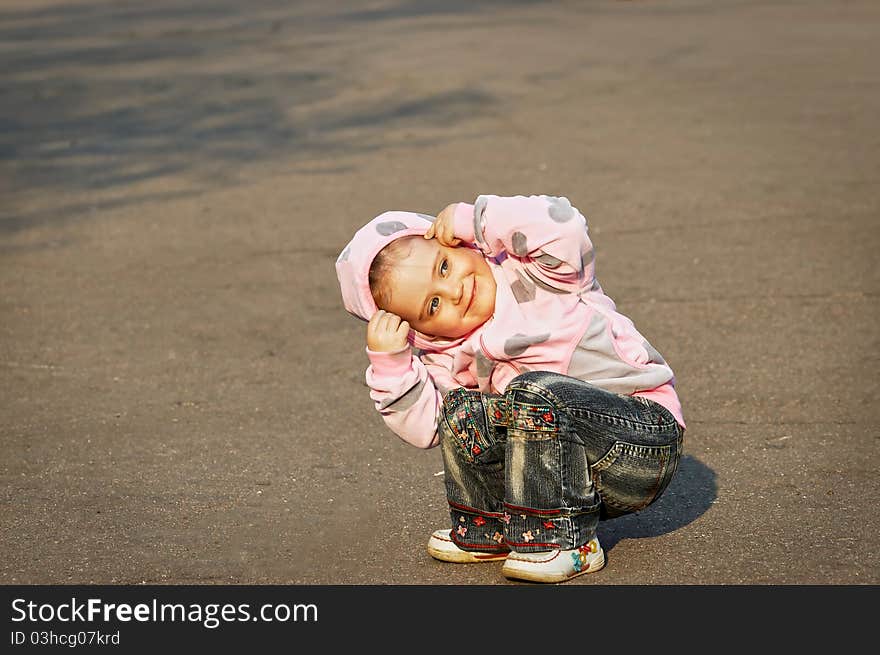 Child playing on the asphalt.Outdoor