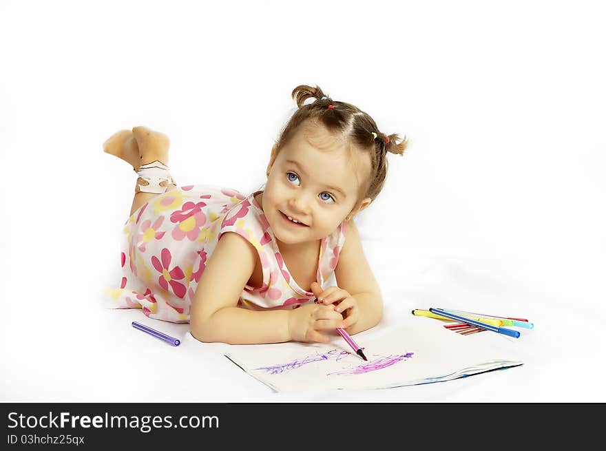 The beautiful girl drawing pencils in a sketch pad on the isolated white background