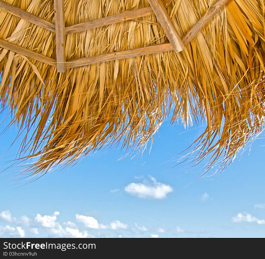 Beach umbrella and blue sky on windy day. Beach umbrella and blue sky on windy day