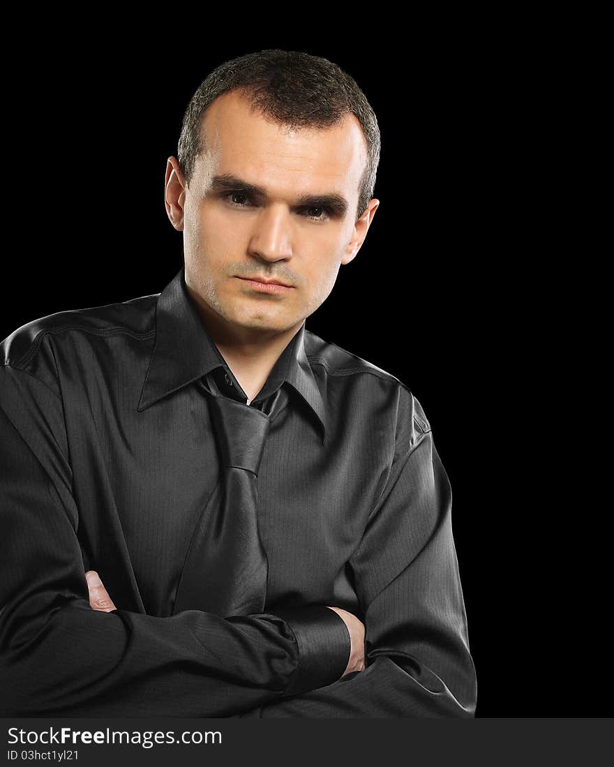 Stylish businessman. Black clothing. On a black background. Stylish businessman. Black clothing. On a black background