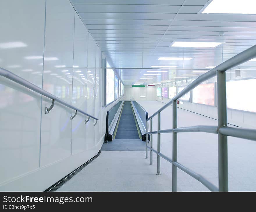 Long corridor with escalator in underground passage. Long corridor with escalator in underground passage