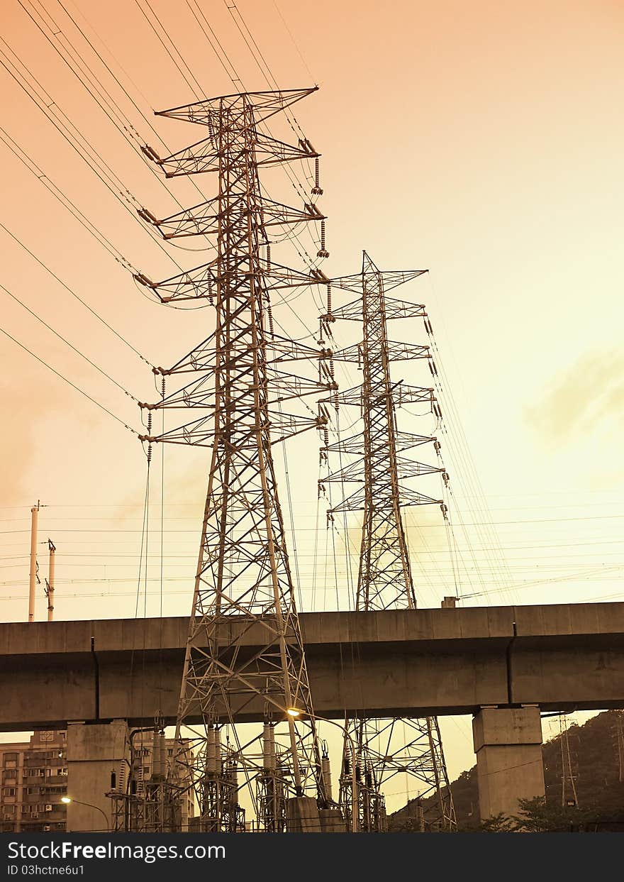 Sunset and electric towers near bridge