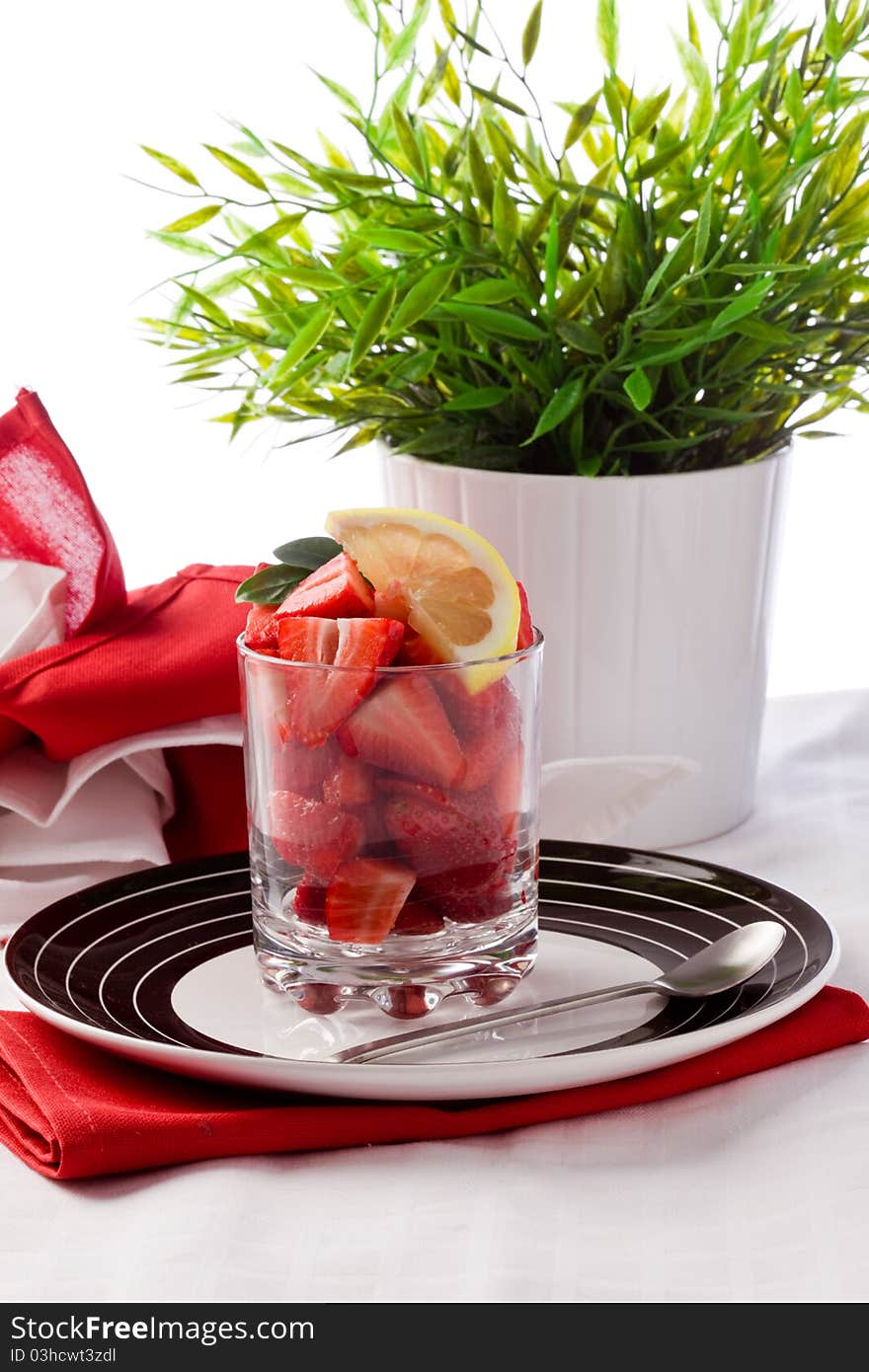 Photo of strawberry salad with sliced lemon on white background. Photo of strawberry salad with sliced lemon on white background