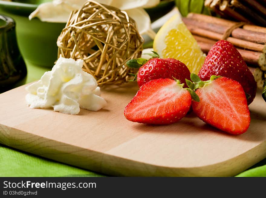 Photo of delicious cutted strawberries with whipped cream. Photo of delicious cutted strawberries with whipped cream