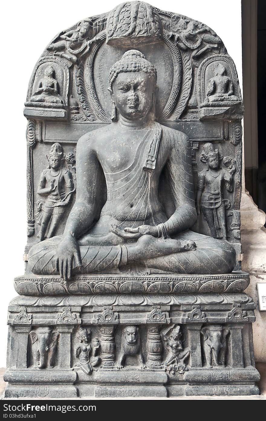 Ancient stone sculpture of Buddha in meditation belonging to 11th century found in Java on display in the Indian Museum in Kolkata, India. Ancient stone sculpture of Buddha in meditation belonging to 11th century found in Java on display in the Indian Museum in Kolkata, India