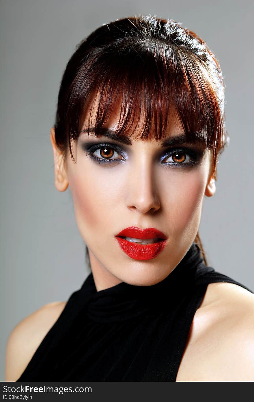 Portrait of an attractive brunette in black dress, sensually looking, with great makeup on her face. Portrait of an attractive brunette in black dress, sensually looking, with great makeup on her face