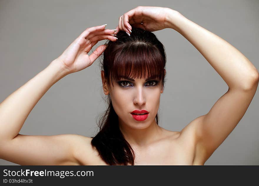 Attractive brunette making her hair. Attractive brunette making her hair