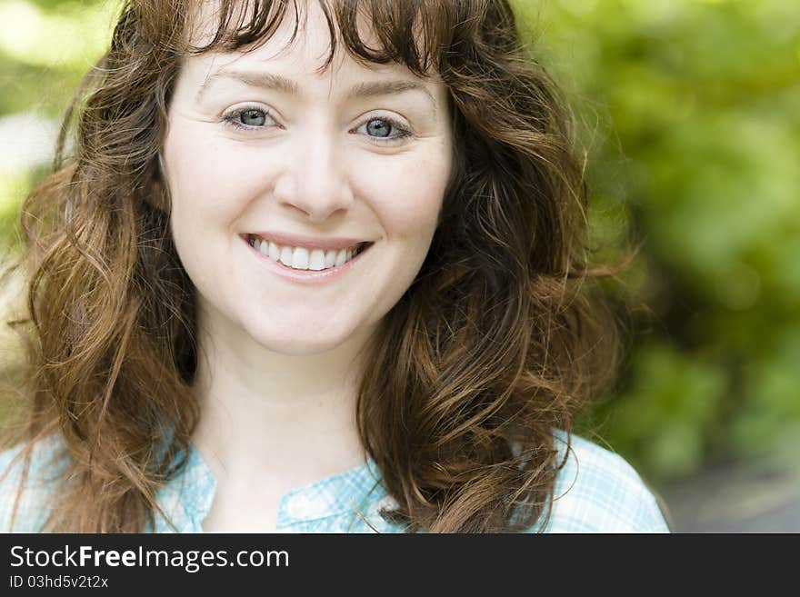 Portrait of a Pretty Young Woman Smiling Directly to the Camera. Portrait of a Pretty Young Woman Smiling Directly to the Camera