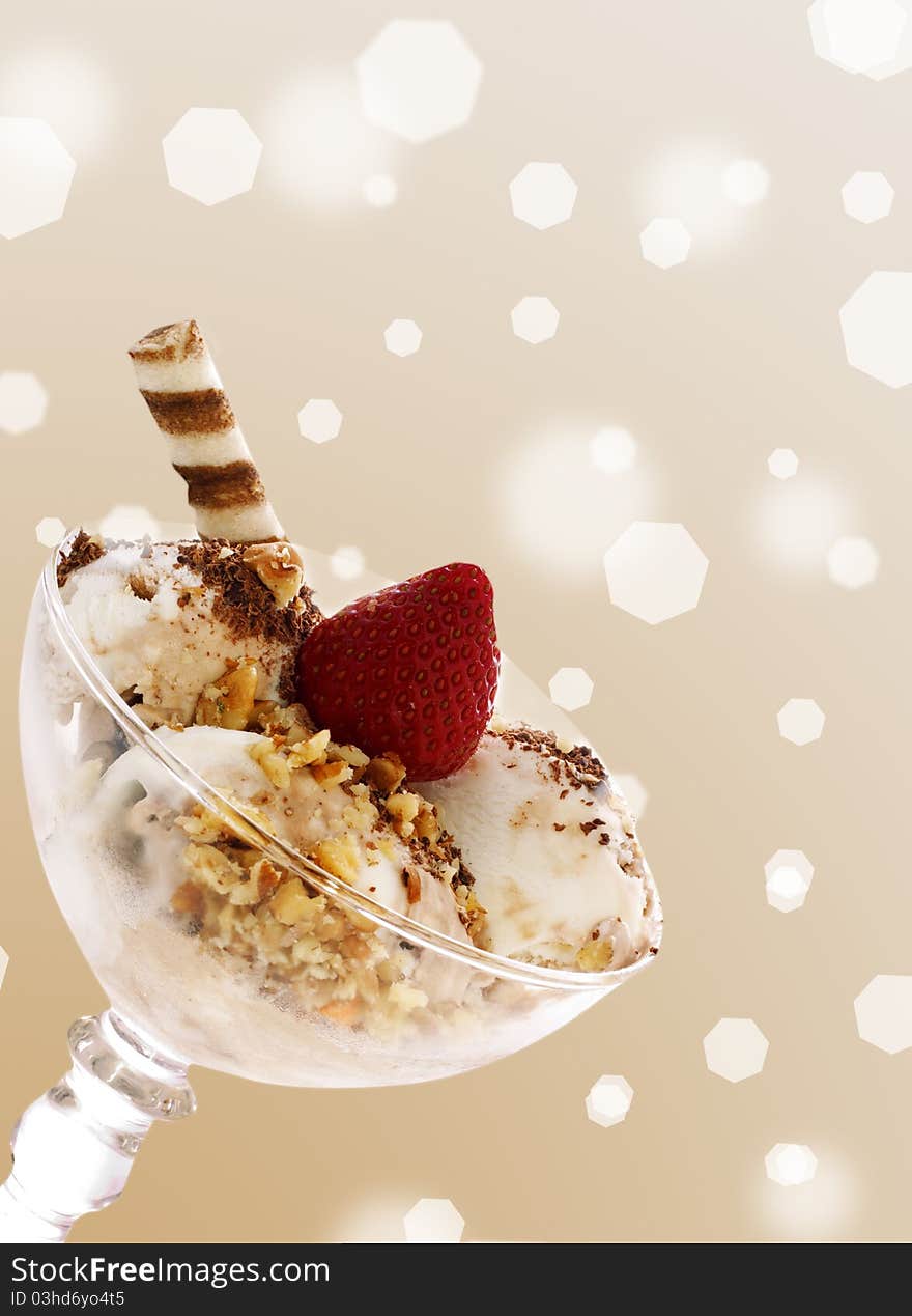 Ice cream with strawberry and nuts in a  glass bowl over brown. Ice cream with strawberry and nuts in a  glass bowl over brown