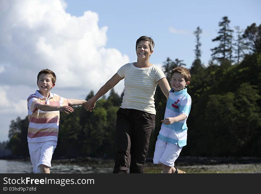 Mother walking with two boys on a beach. Mother walking with two boys on a beach