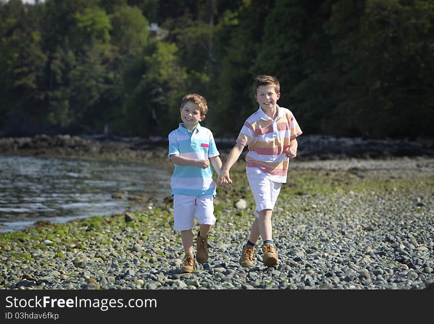 Two boys walking on a beach. Two boys walking on a beach