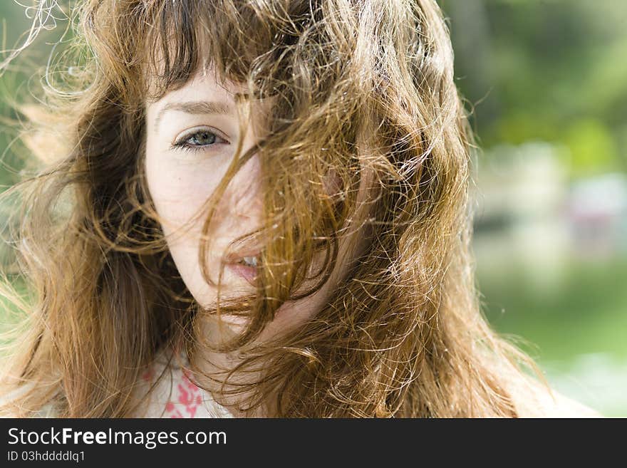 Portrait of a Pretty Young Woman with Windblown Hair across Her Face. Portrait of a Pretty Young Woman with Windblown Hair across Her Face