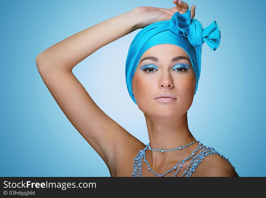 Young woman in blue scarf on the head with health skin of face