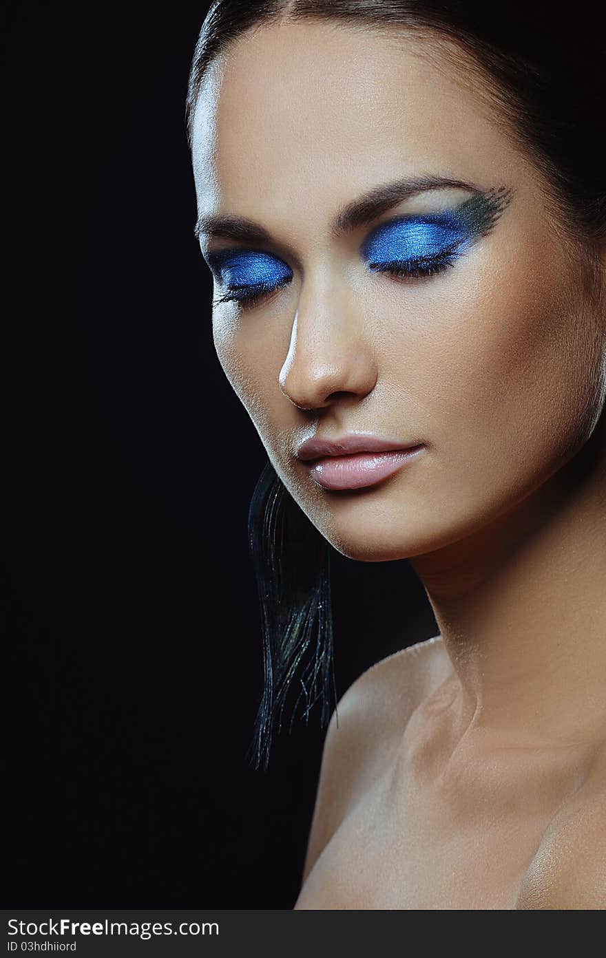 Beautiful girl with blue make-up in long earrings. Beautiful girl with blue make-up in long earrings