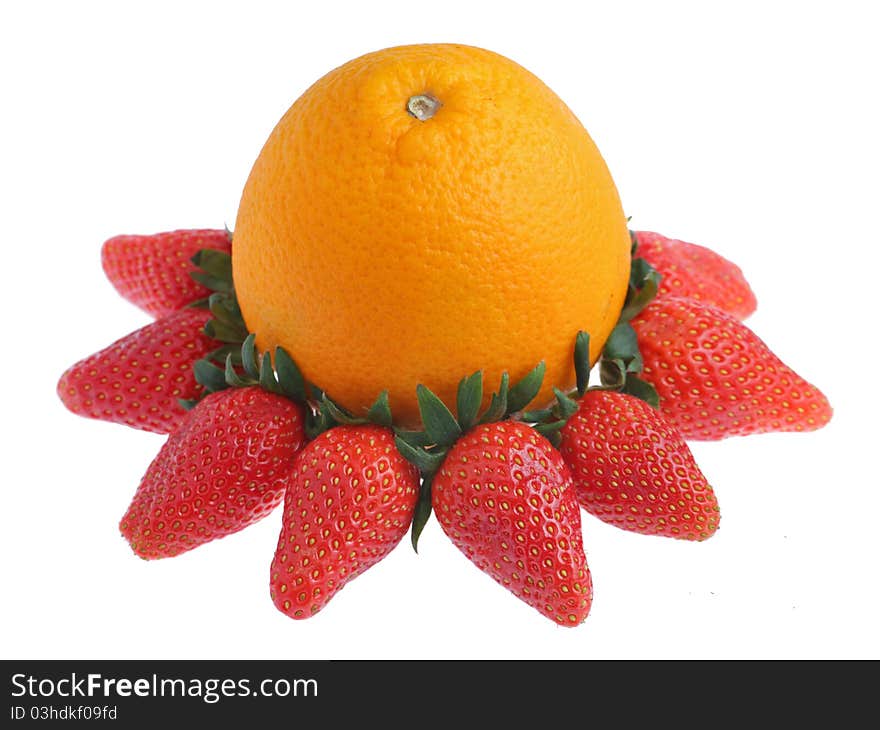 An orange surrounded with strawberries isolated on white background. An orange surrounded with strawberries isolated on white background.