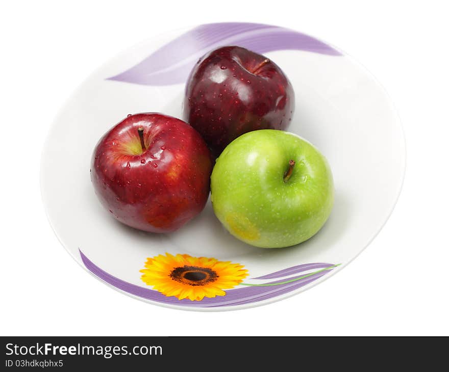 Three green apples in plate isolated on white background. Three green apples in plate isolated on white background.