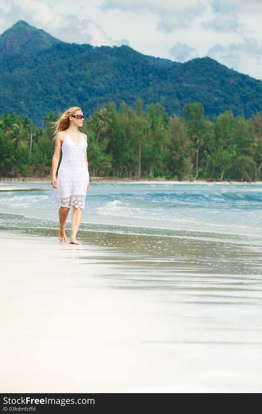 Woman walks on a beach