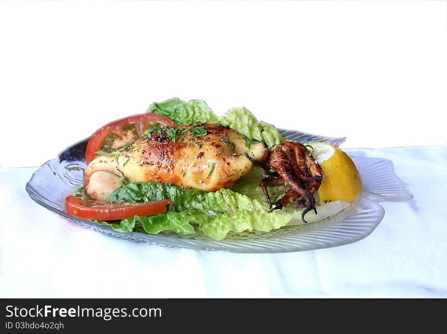 Calamari with salad on a glass plate