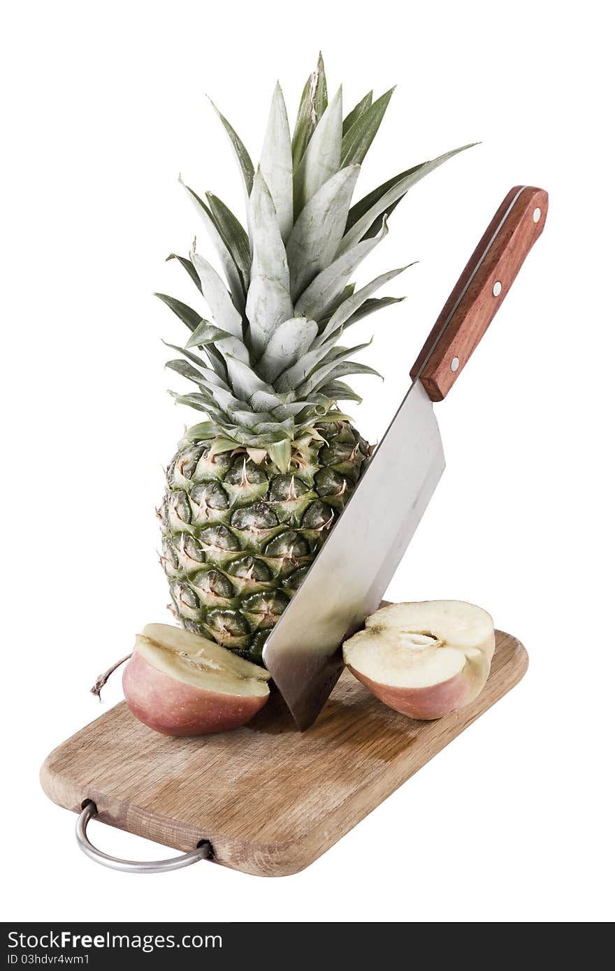 Apple and pineapple on desk with knife, white background