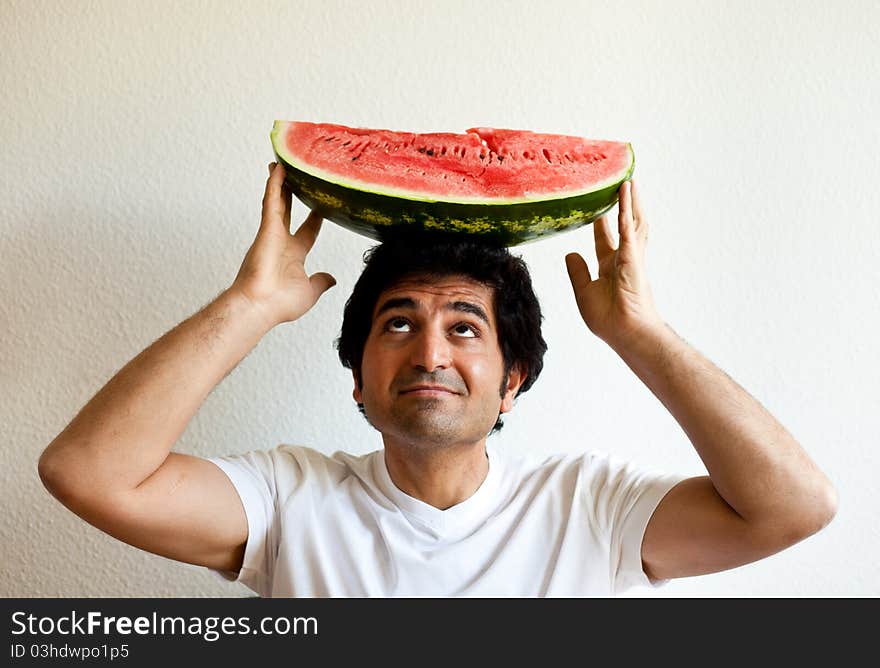 Man holding a watermelon on his head