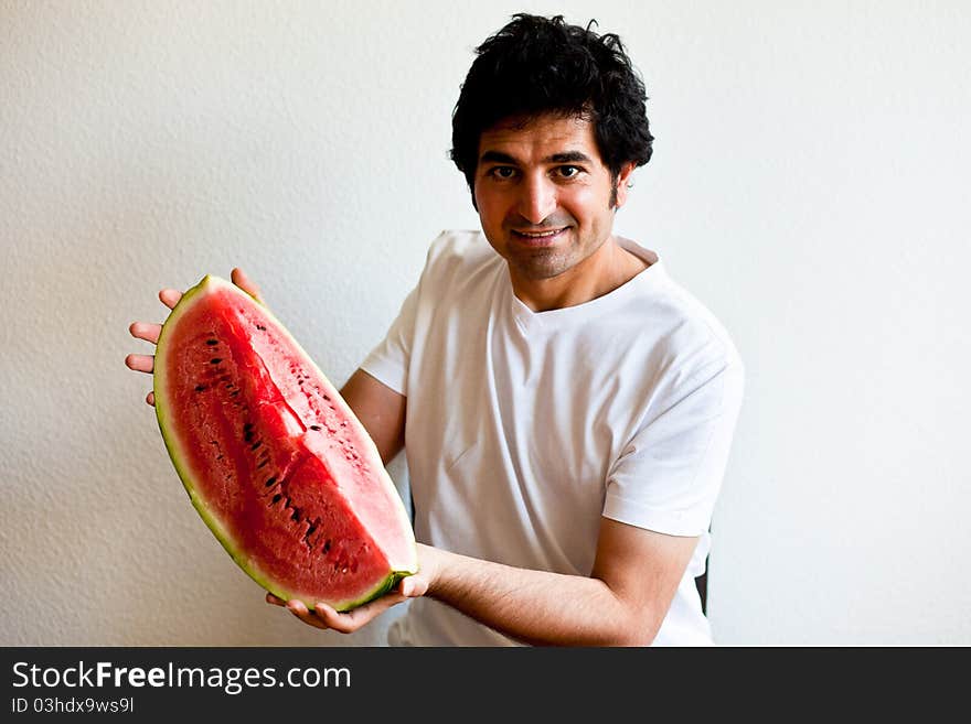 Man holding a  big slice of watermelon