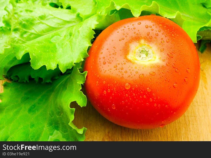 A red tomato on the wooden table