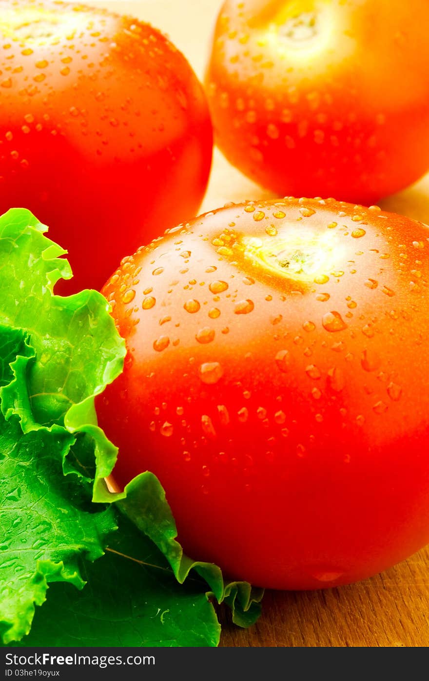 A red tomato on the wooden table