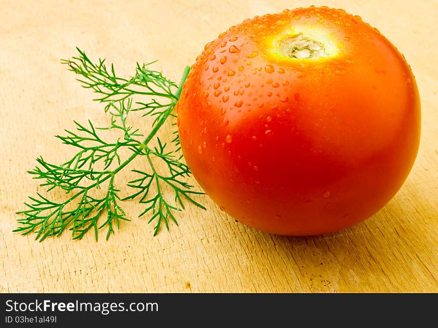 A red tomato on the wooden table