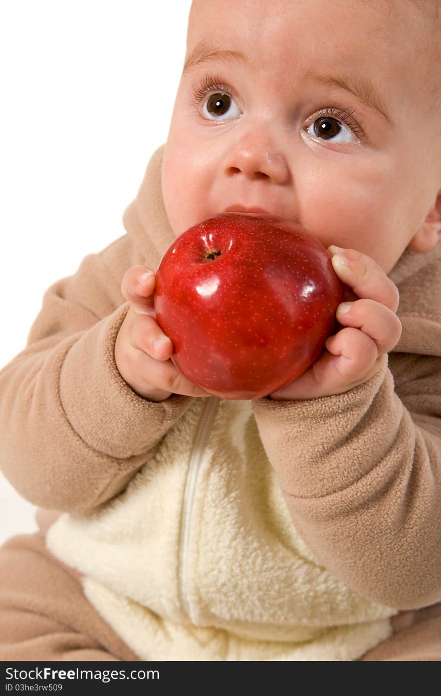 Baby holding and eating an apple