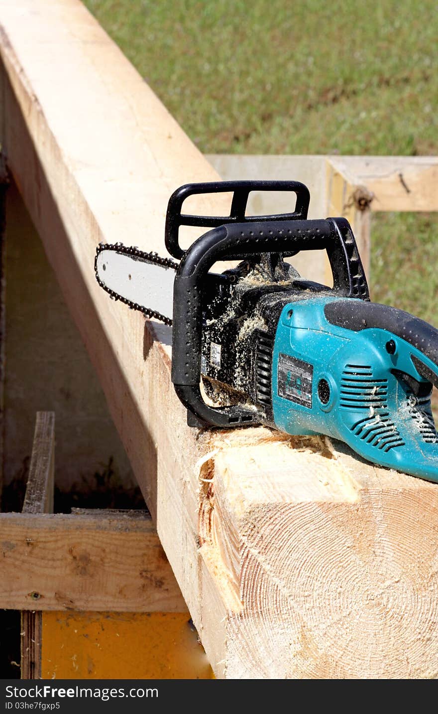 A chain saw and wood on the building site