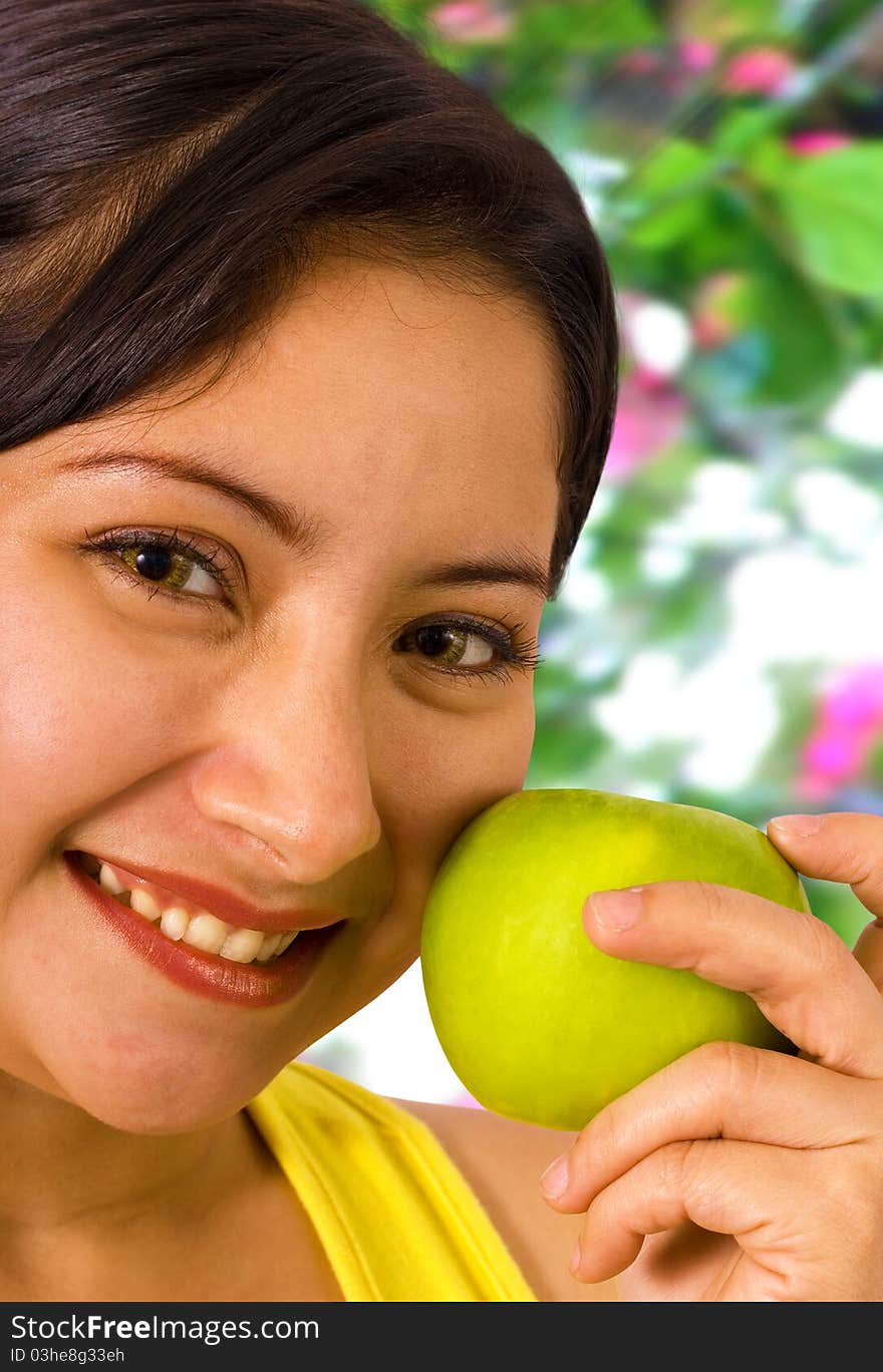 Young Lady Smiling In The Garden About To Eat An Apple. Young Lady Smiling In The Garden About To Eat An Apple