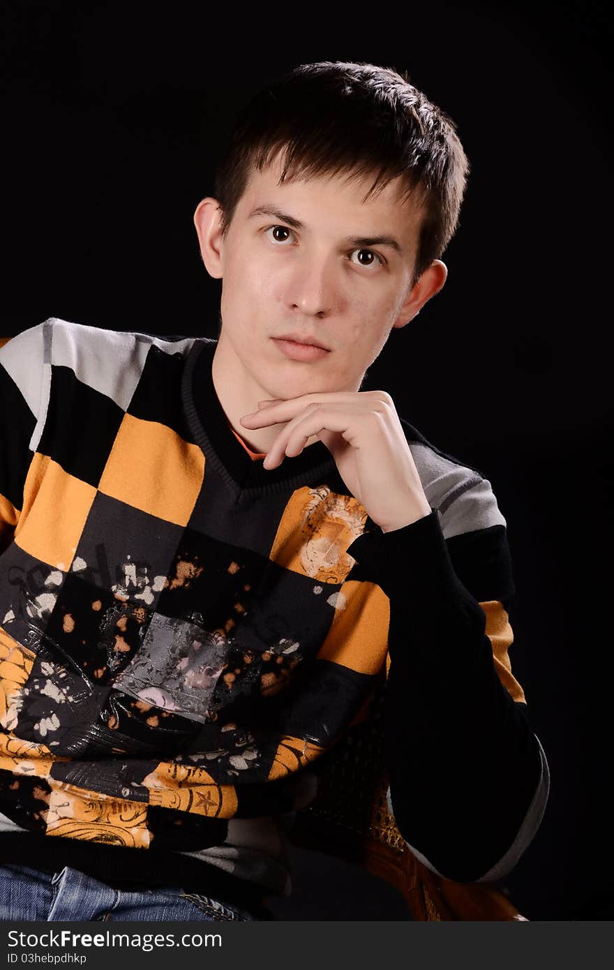 Portrait of a handsome young man on black background. Studio shot