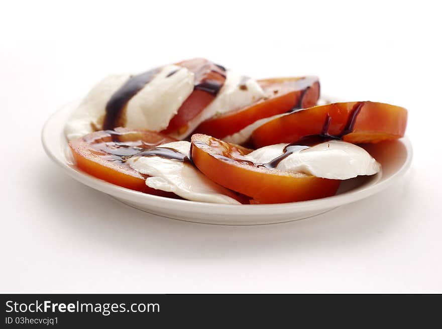 Mozarella and tomatoes isolated on white background. Mozarella and tomatoes isolated on white background