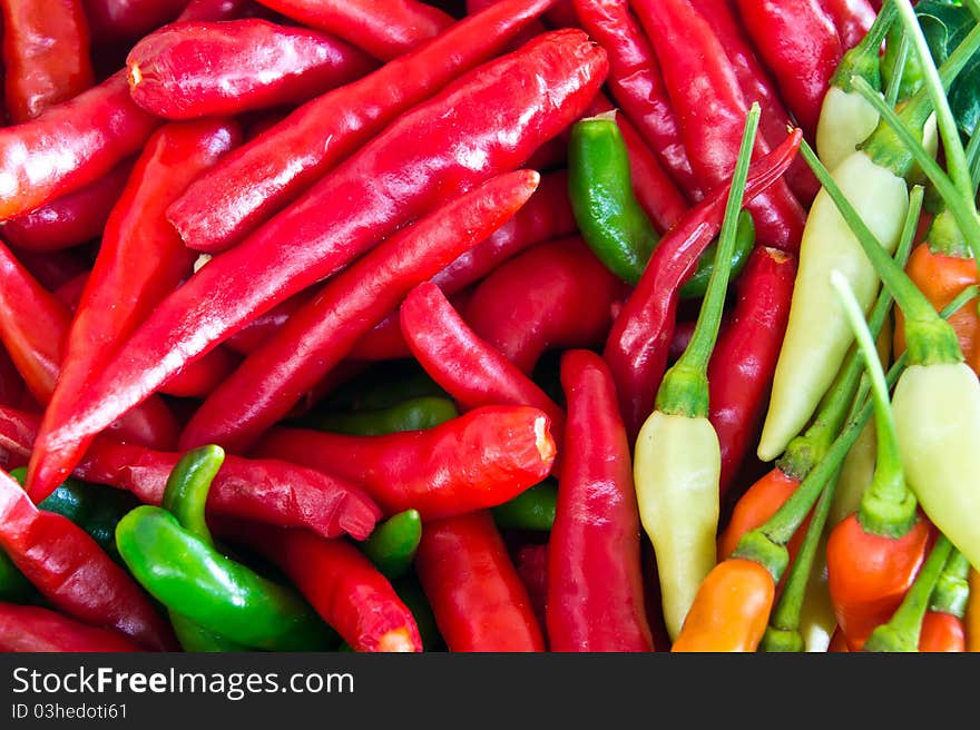 Background of closeup colorful chilies. Background of closeup colorful chilies.