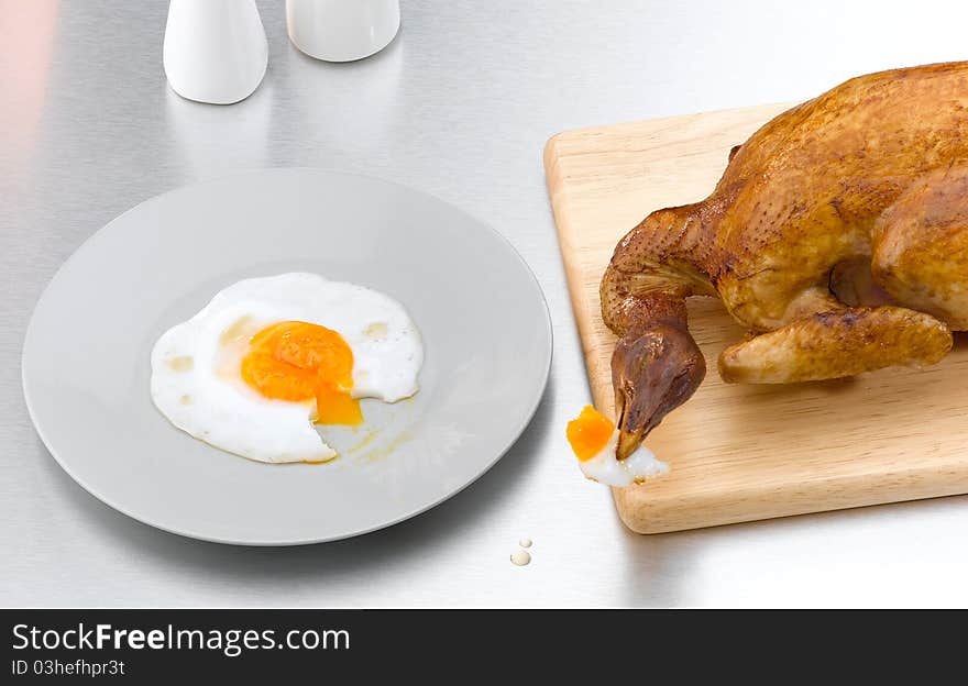 Conceptual image of the died chicken toasted but still hungry, the image isolated in the kitchen . Conceptual image of the died chicken toasted but still hungry, the image isolated in the kitchen