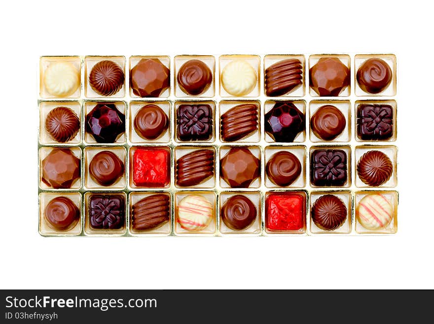 Colorful chocolates in box isolated on white