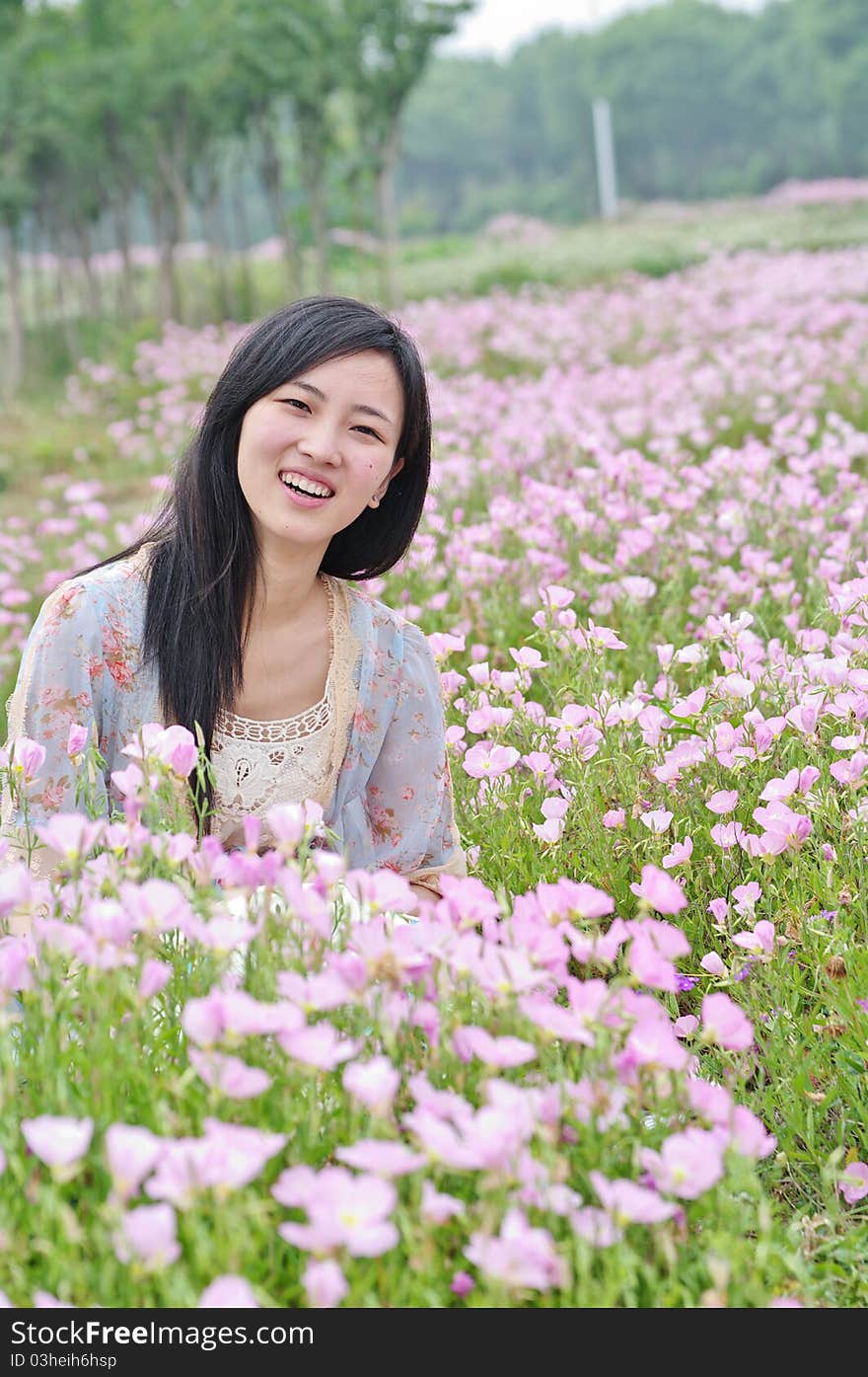 A girl in field with flowers around. A girl in field with flowers around