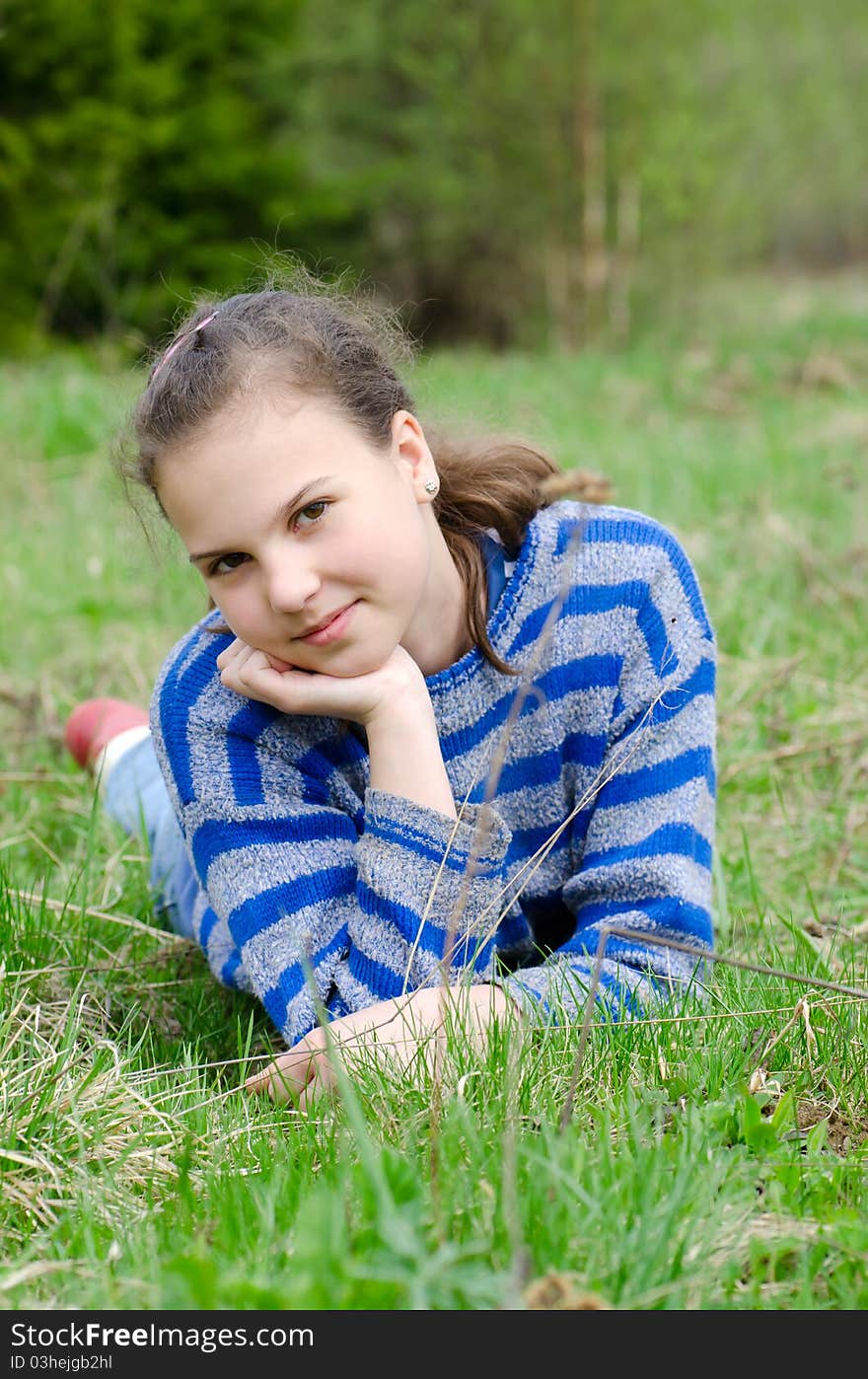 Portrait of the girl Against green wood