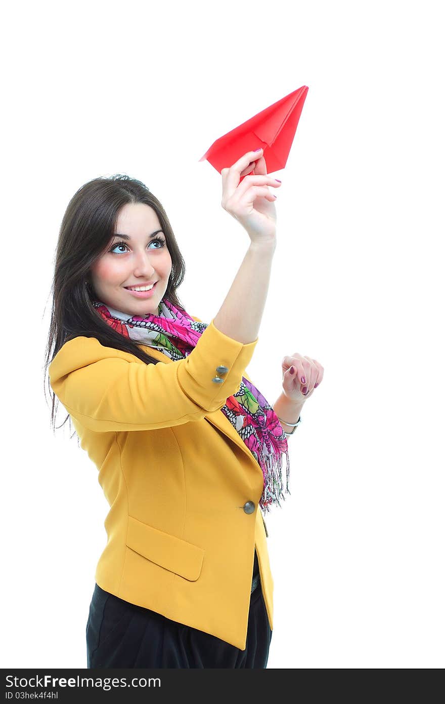 Young charming brunette launching a paper airplan against white background