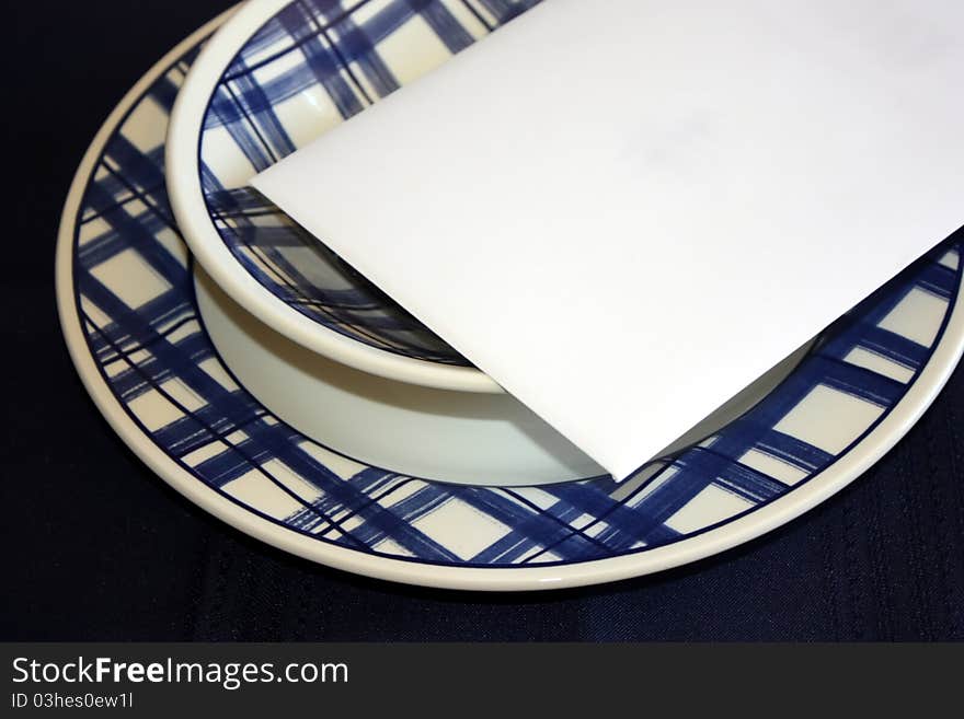 Write your message on this white envelope placed on colorful plate and bowl. Write your message on this white envelope placed on colorful plate and bowl